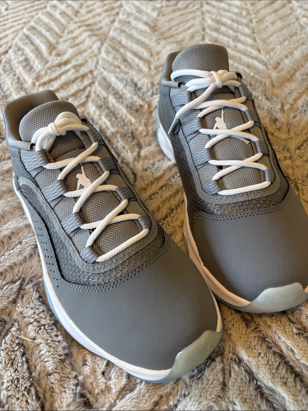 grey Nike Air Jordan 11 CMFT Low youth sneakers.